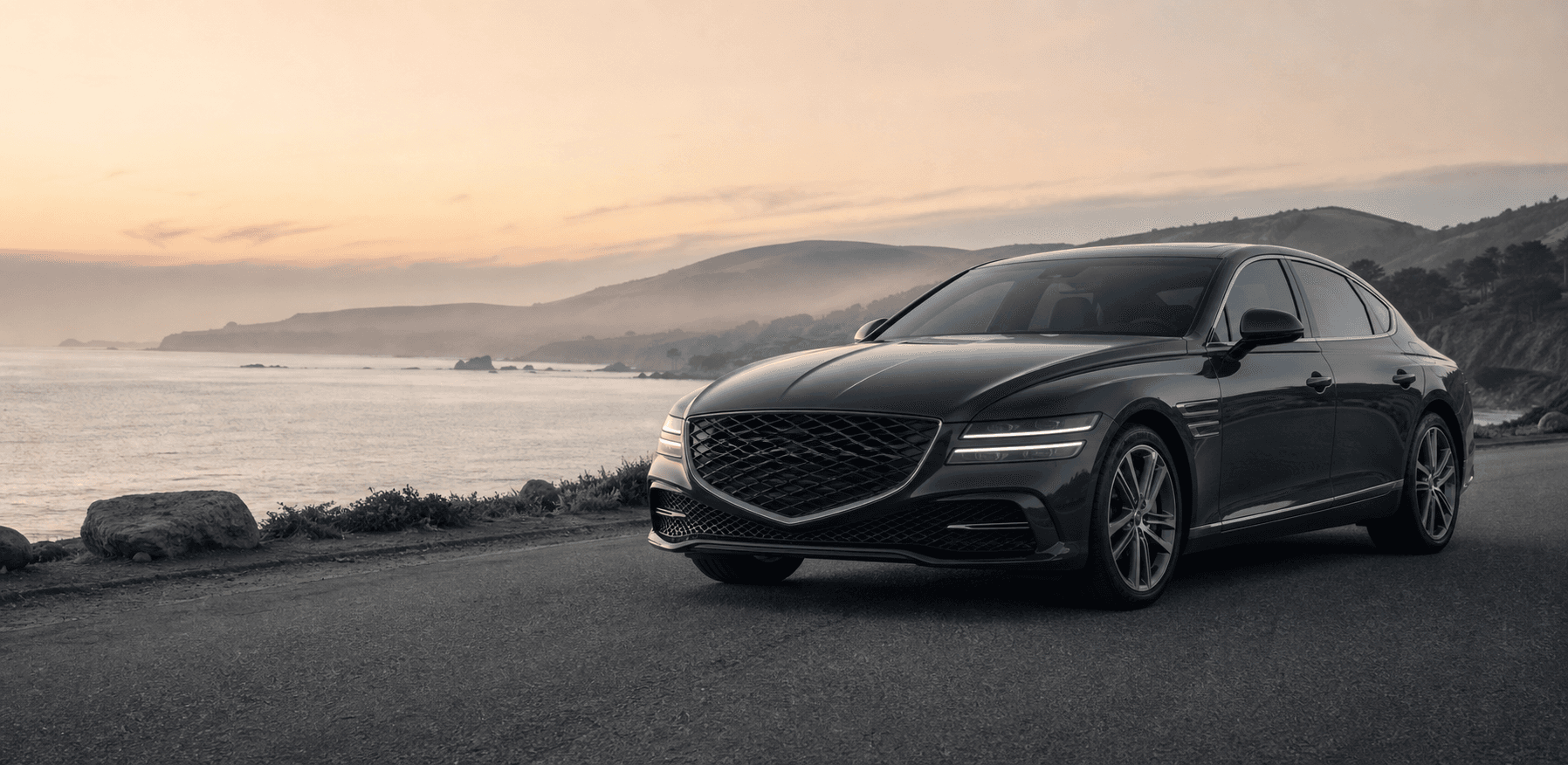 Modern graphite car on a quiet coastal road